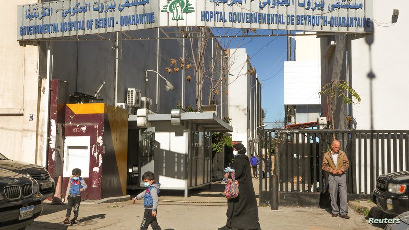 People walk outside the Karantina Governmental Hospital in Beirut موظفو مستشفى بيروت الحكومي الى الاعتصام غدا