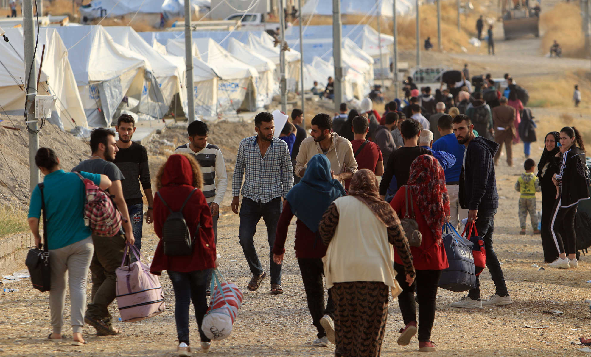 Syrian displaced families, who fled violence after the Turkish offensive in Syria, are seen upon arrival at a refugee camp in Bardarash on the outskirts of Dohuk بعد إصرار لبنان، داتا النازحين مطلع كانون