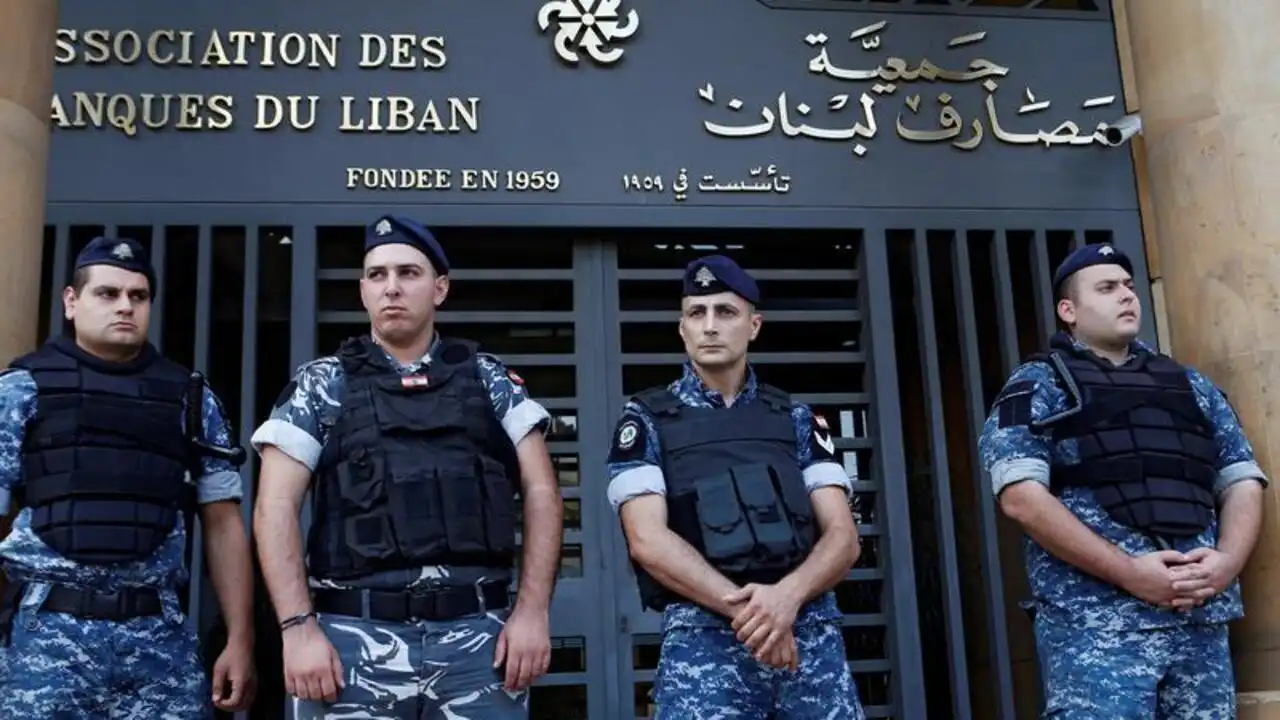 Lebanese police stand outside the entrance of the Association of Banks in downtown Beirut